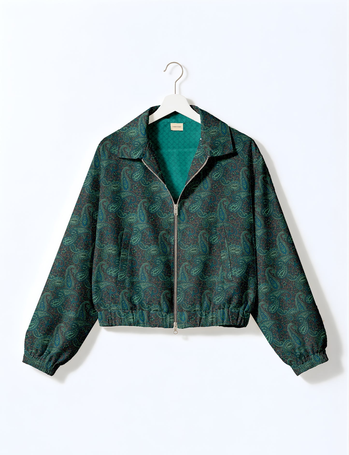 Women's cropped bomber jacket with twin metallic front zippers, welt pockets, elasticated hem and cuffs, and contrast sari print lining.