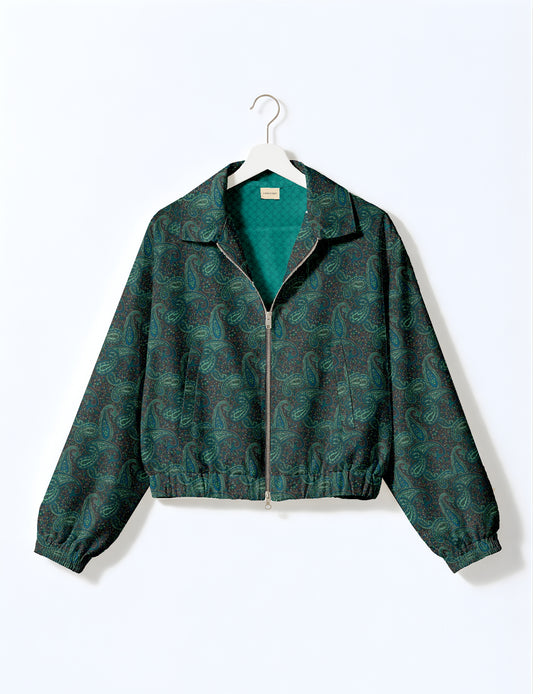Women's cropped bomber jacket with twin metallic front zippers, welt pockets, elasticated hem and cuffs, and contrast sari print lining.