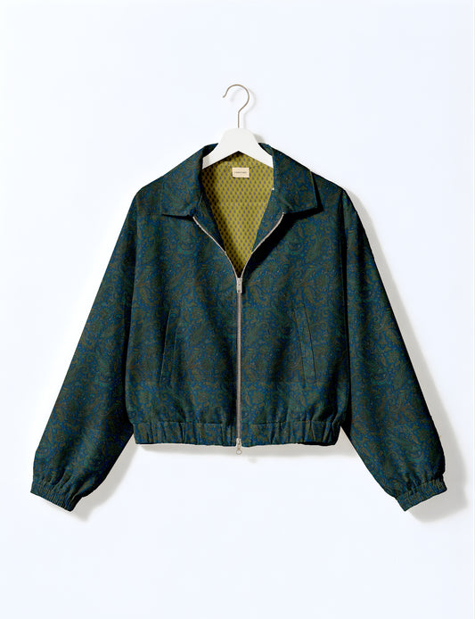 Women's cropped bomber jacket with twin metallic front zippers, welt pockets, elasticated hem and cuffs, and contrast sari print lining.