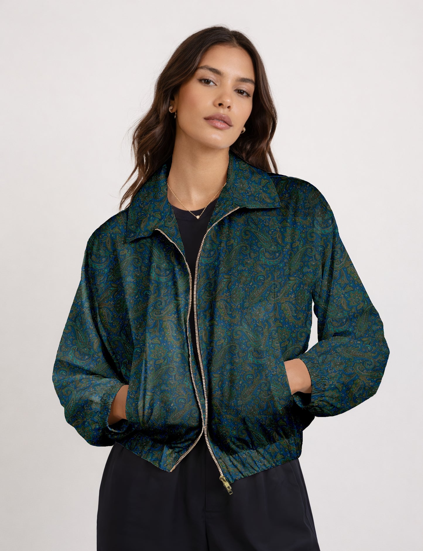 Women's cropped bomber jacket with twin metallic front zippers, welt pockets, elasticated hem and cuffs, and contrast sari print lining.