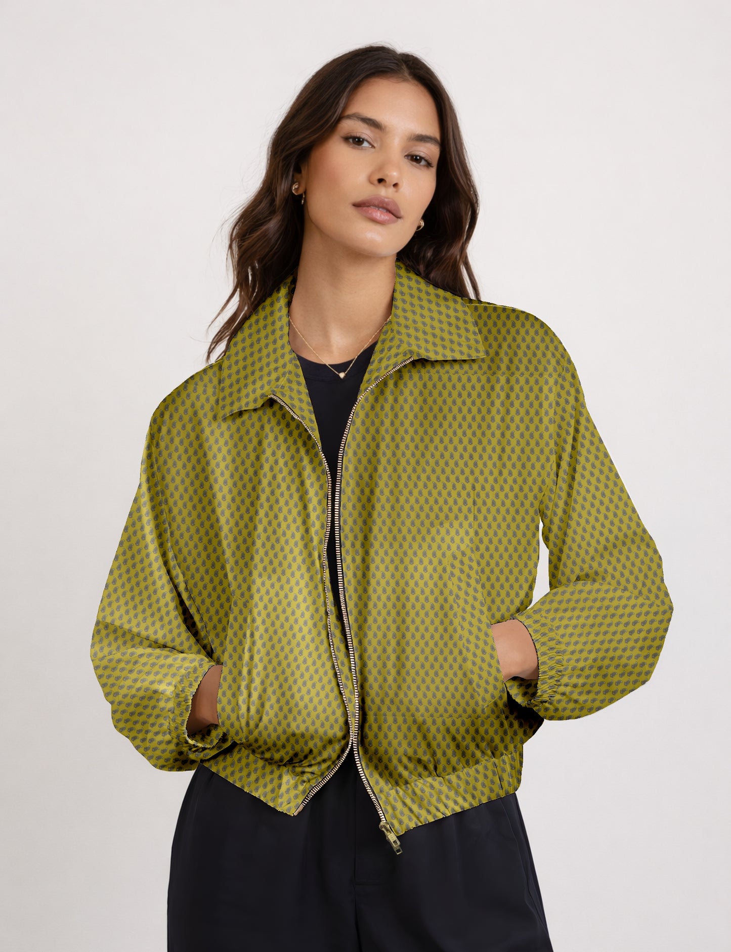 Women's cropped bomber jacket with twin metallic front zippers, welt pockets, elasticated hem and cuffs, and contrast sari print lining.