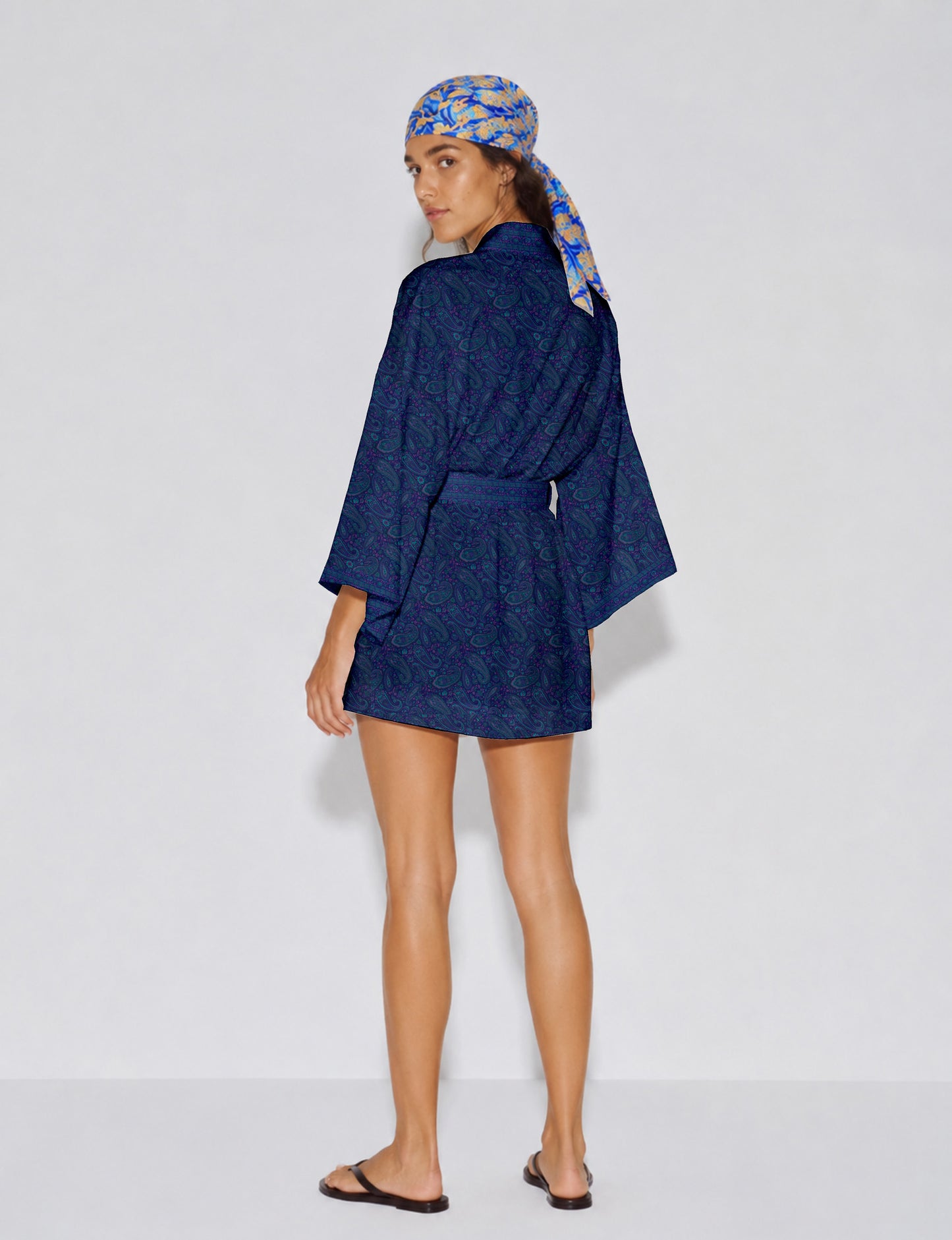 Short kimono robe with wrap front, V-neckline, wide sleeves, waist tie, and concealed skort detail.
