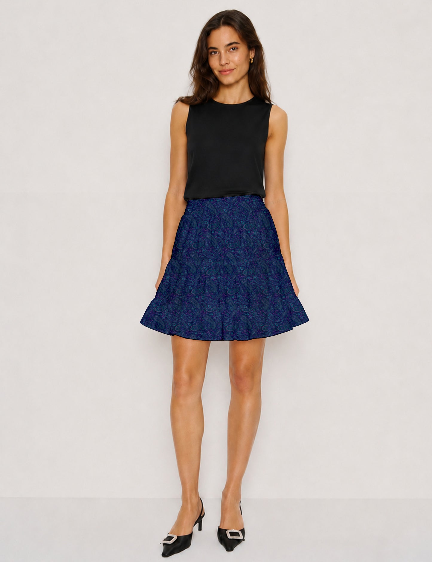 Short tiered skirt with a fitted waistband, knife pleats, softly flared silhouette, side seam pockets, and above-the-knee length.