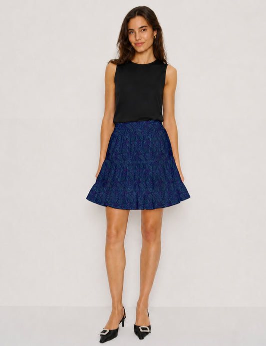 Short tiered skirt with a fitted waistband, knife pleats, softly flared silhouette, side seam pockets, and above-the-knee length.