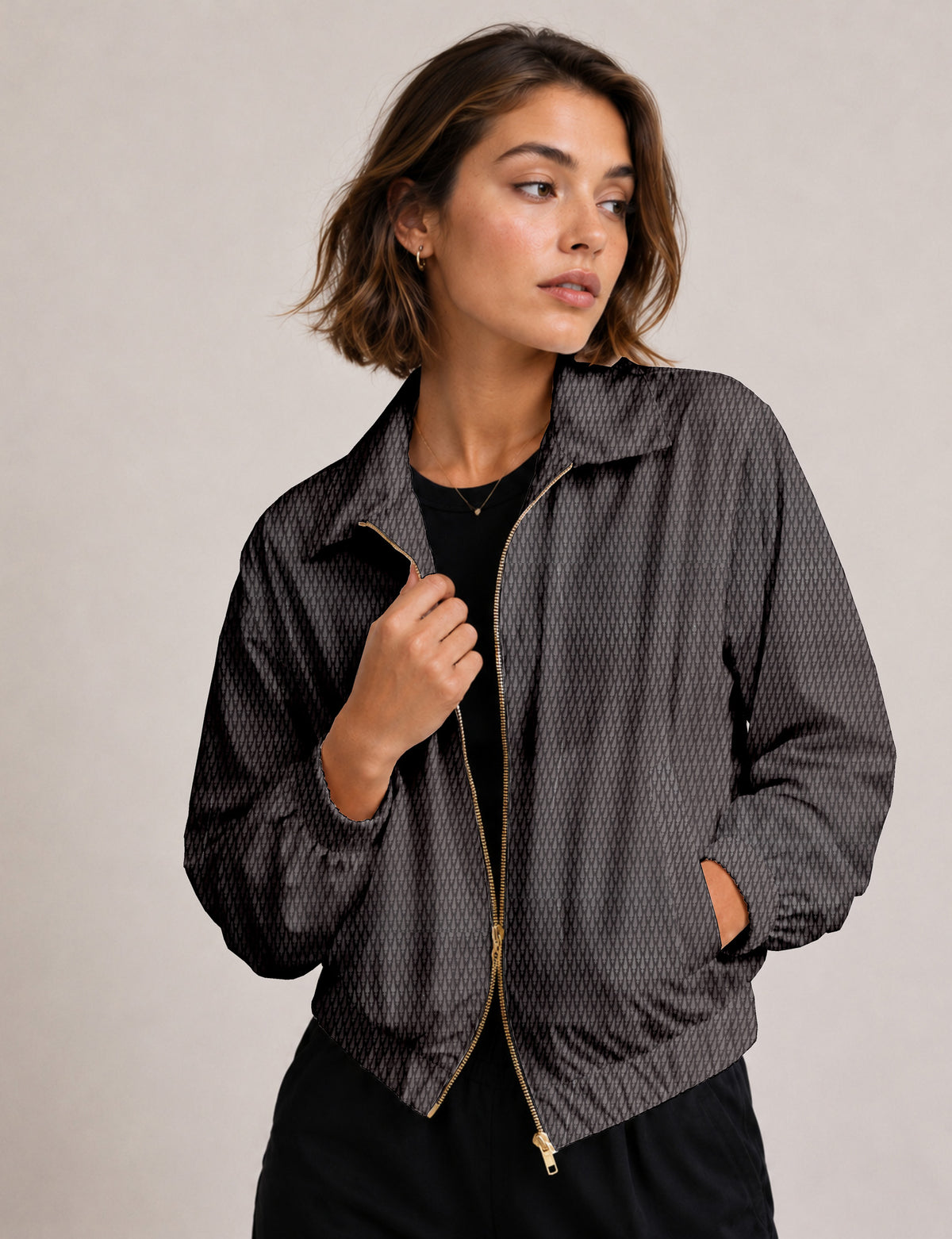 Brown floral bomber jacket with front zipper, elastic cuffs and hem, hanging on white hanger, red floral inner lining visible