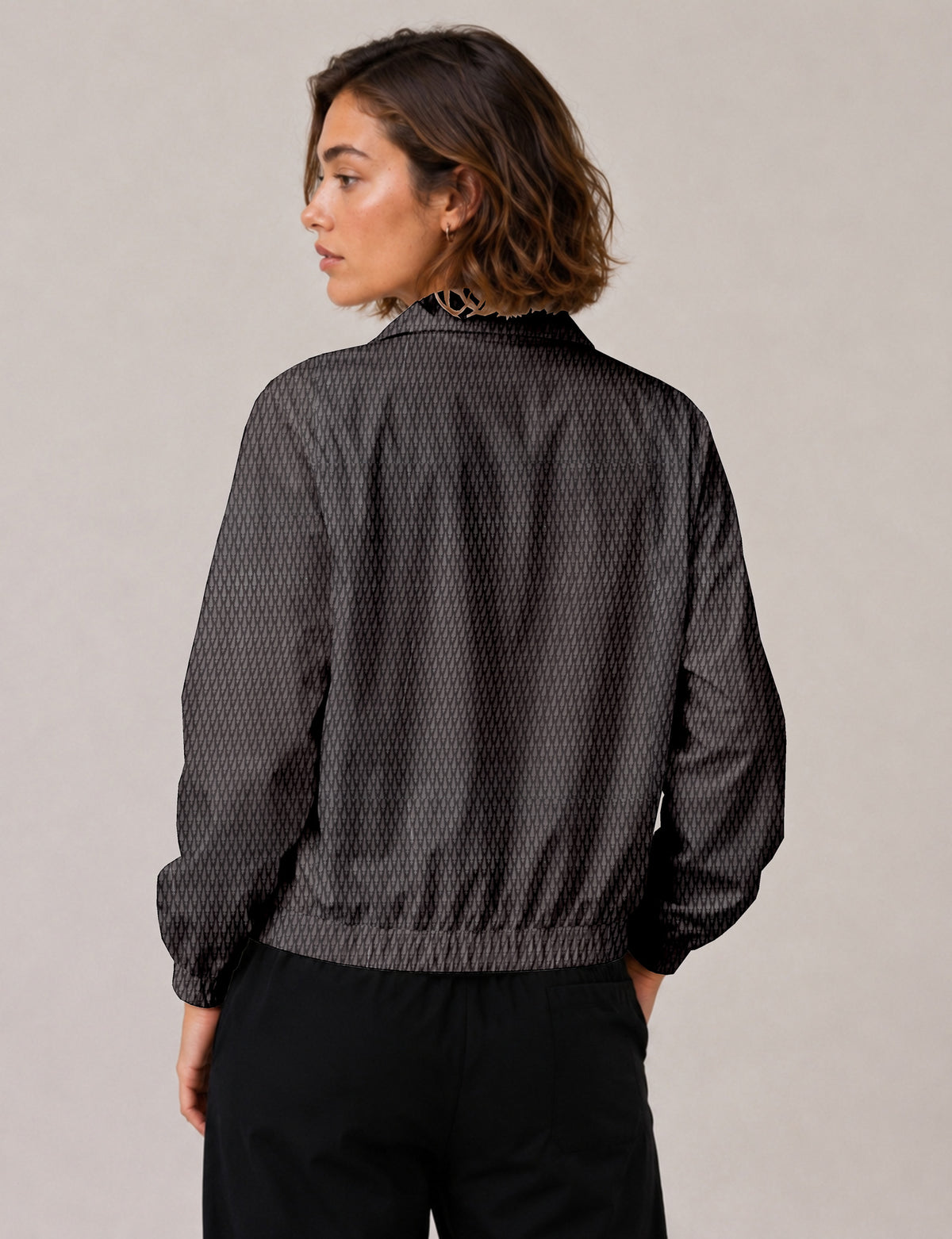 Woman wearing a yellow floral bomber jacket with front zipper, elastic cuffs, and side pockets, shown from front view