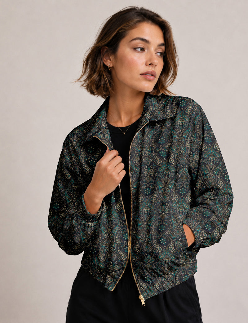 Woman wearing a yellow floral bomber jacket with front zipper, elastic cuffs, and side pockets, shown from front view