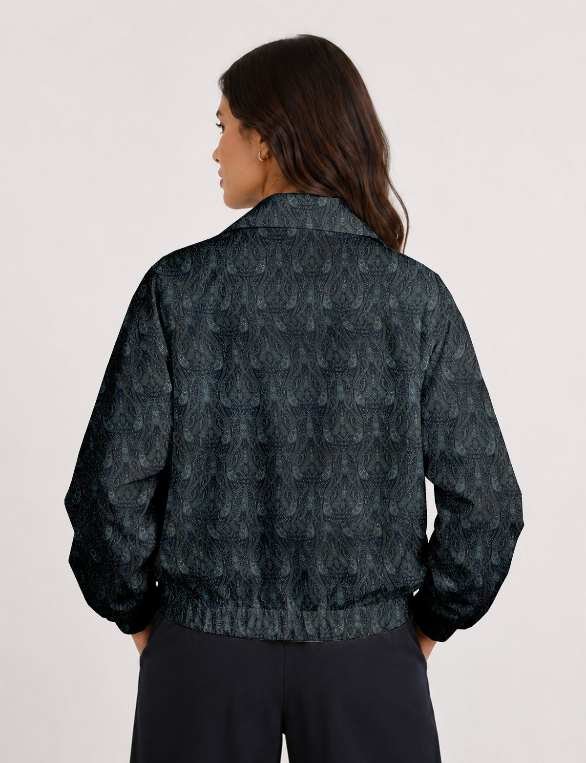 Brown floral bomber jacket with front zipper, elastic cuffs and hem, hanging on white hanger, red floral inner lining visible