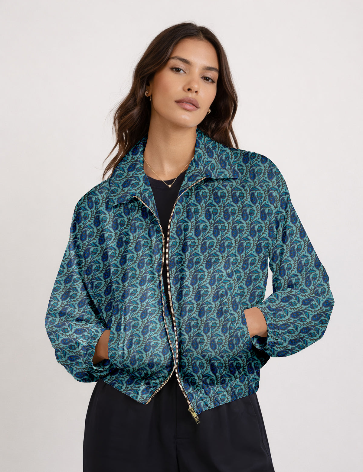 Brown floral bomber jacket with front zipper, elastic cuffs and hem, hanging on white hanger, red floral inner lining visible