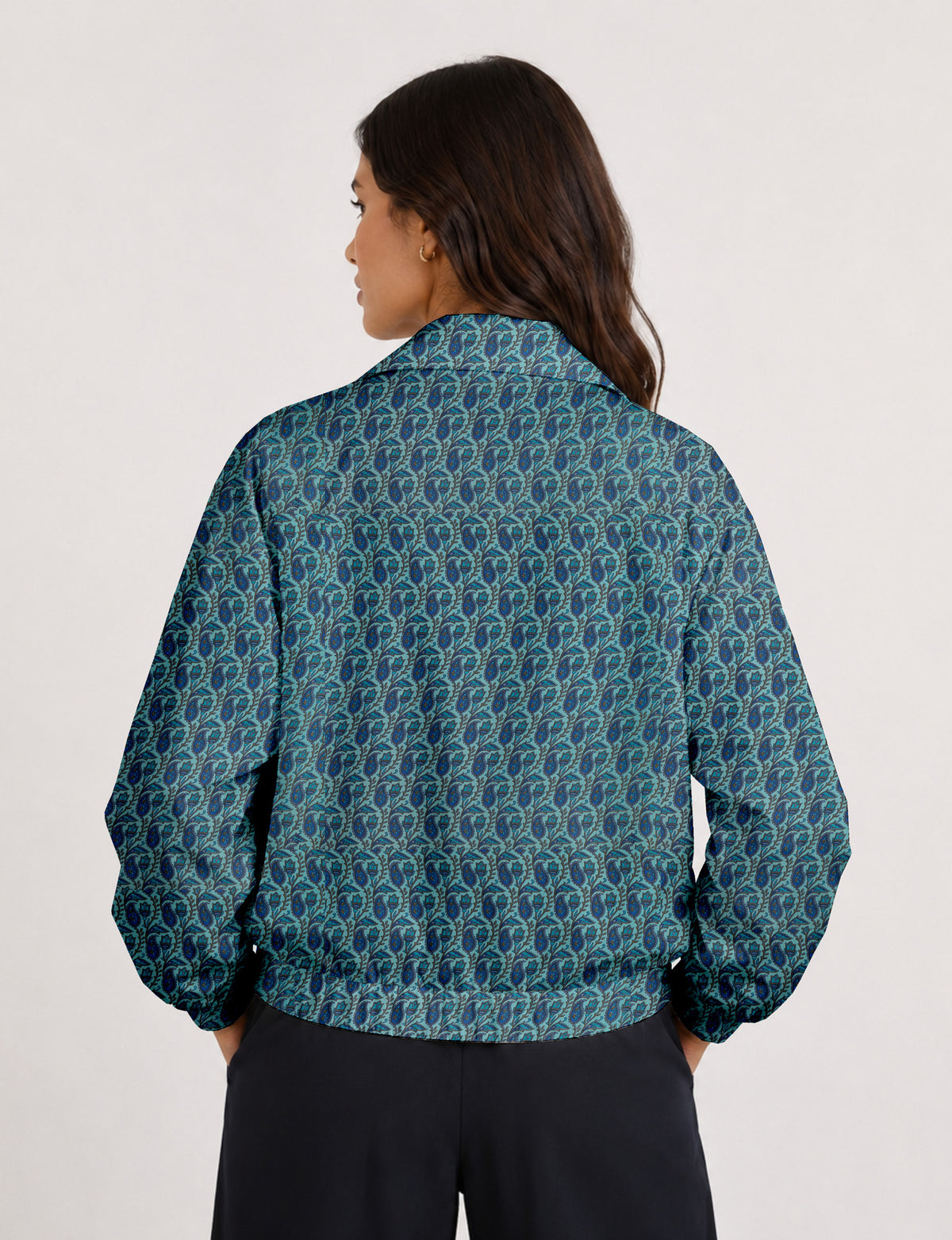 Woman wearing a yellow floral bomber jacket with front zipper, elastic cuffs, and side pockets, shown from front view