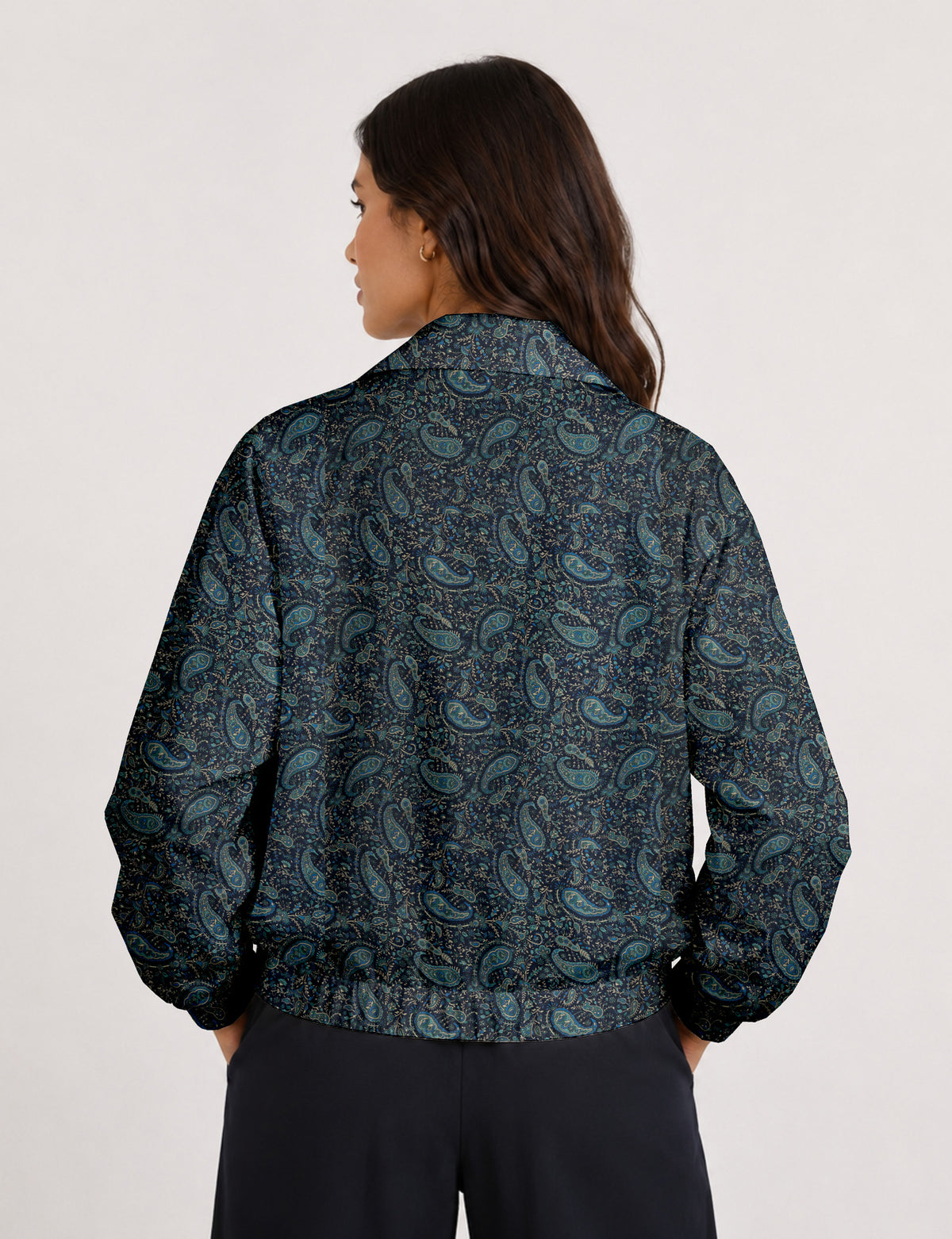 Brown floral bomber jacket with front zipper, elastic cuffs and hem, hanging on white hanger, red floral inner lining visible