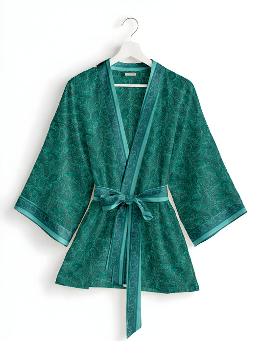 Short kimono robe with wrap front, V-neckline, wide sleeves, waist tie, and concealed skort detail.