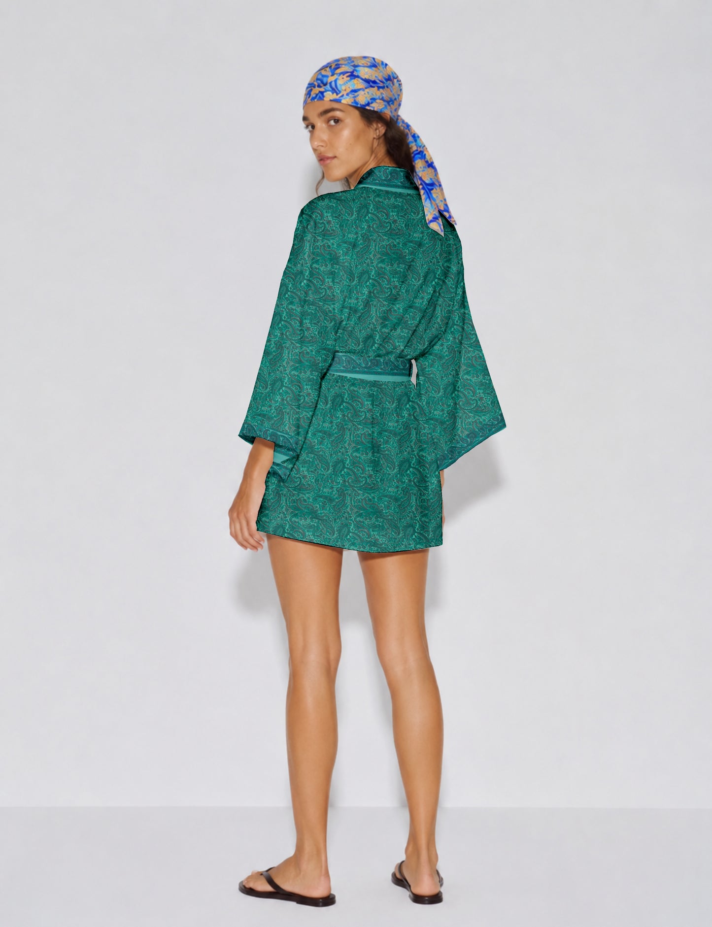 Short kimono robe with wrap front, V-neckline, wide sleeves, waist tie, and concealed skort detail.