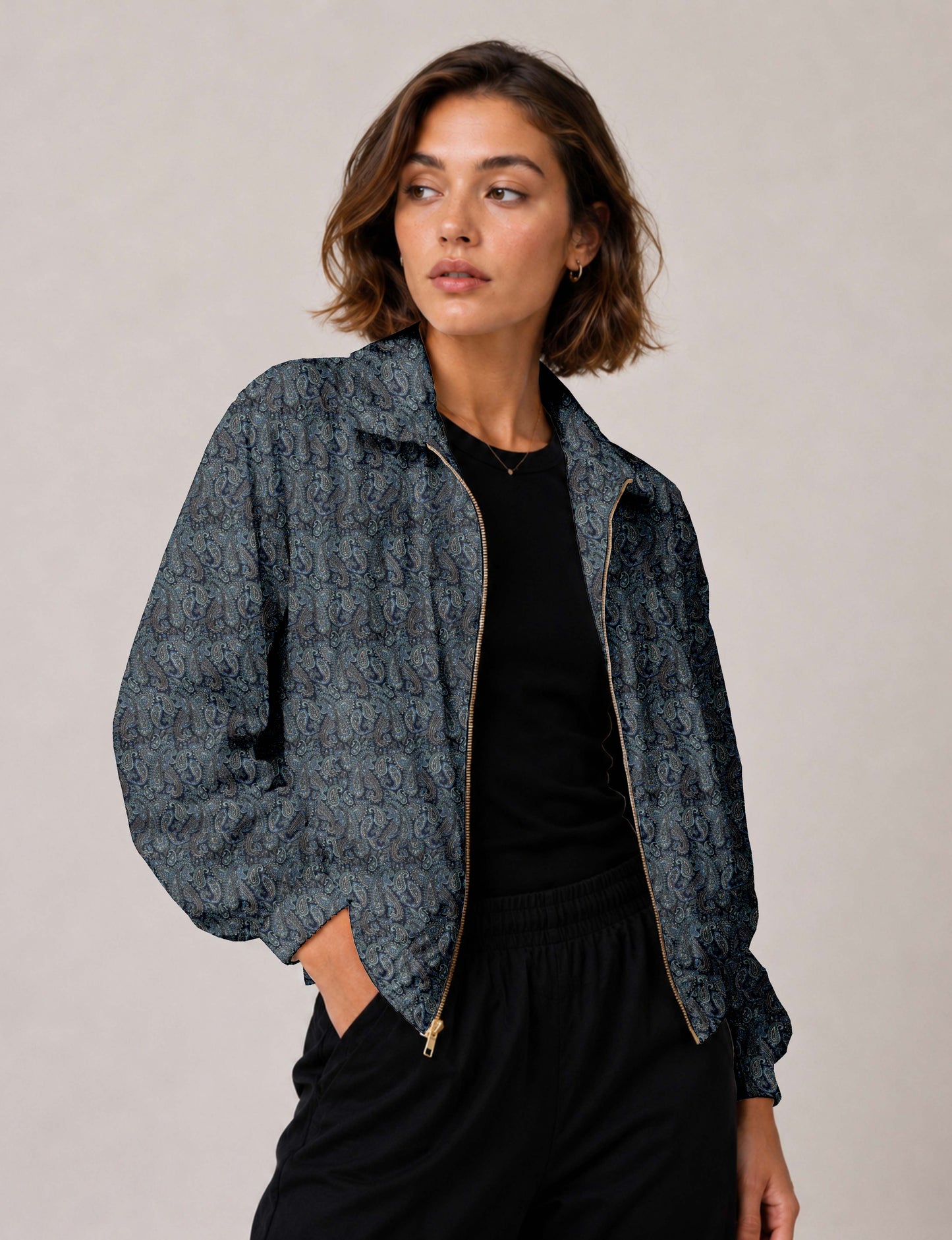 Woman wearing a yellow floral bomber jacket with front zipper, elastic cuffs, and side pockets, shown from front view