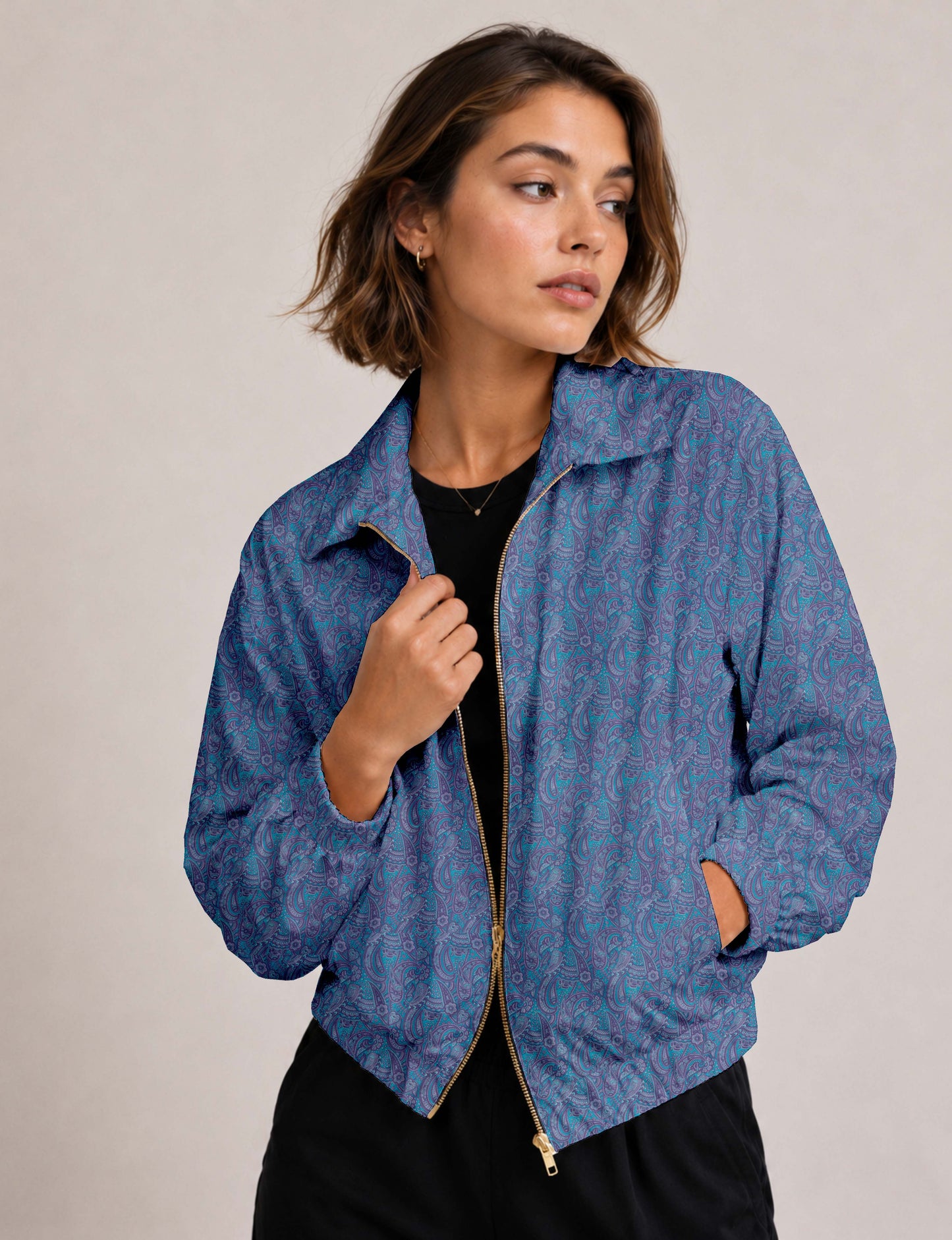 Woman wearing a yellow floral bomber jacket with front zipper, elastic cuffs, and side pockets, shown from front view