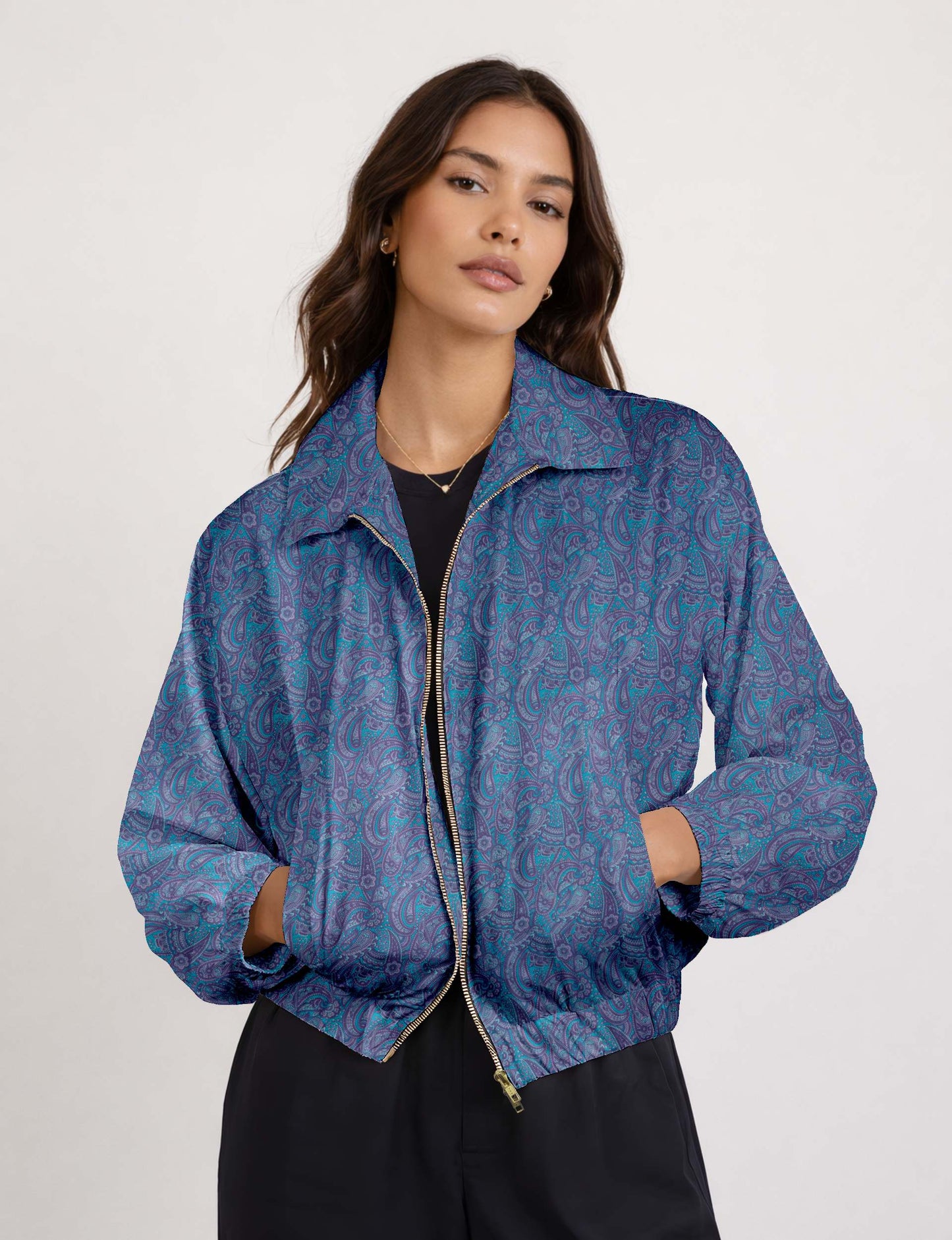 Woman wearing a yellow floral bomber jacket with front zipper, elastic cuffs, and side pockets, shown from front view