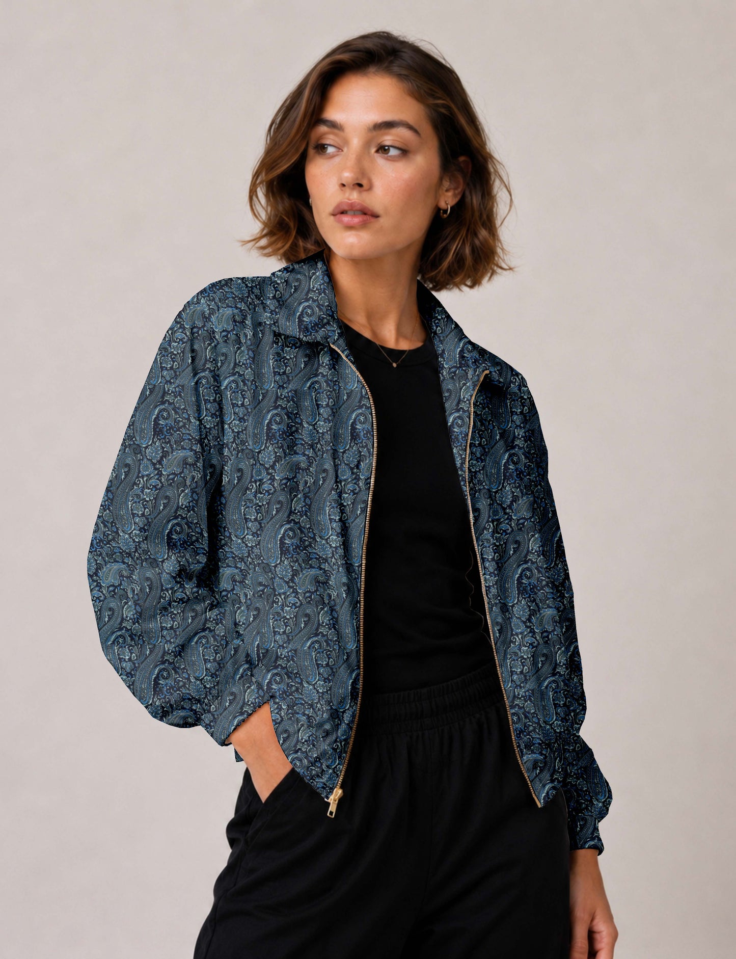 Woman wearing a yellow floral bomber jacket with front zipper, elastic cuffs, and side pockets, shown from front view