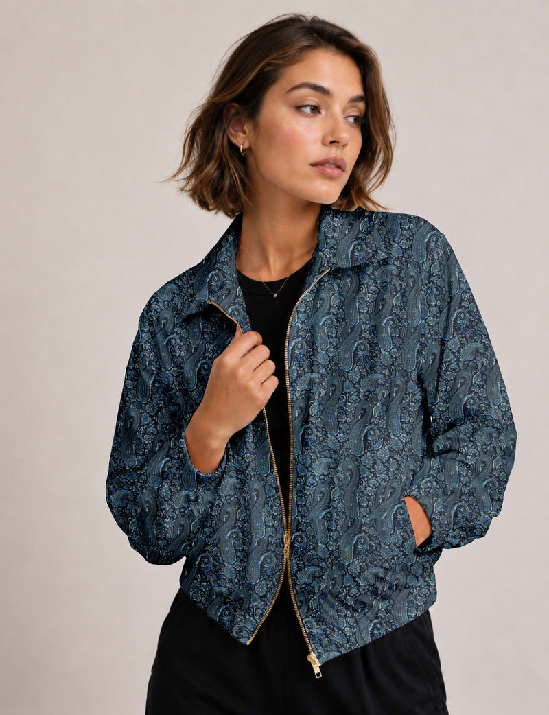 Woman wearing a yellow floral bomber jacket with front zipper, elastic cuffs, and side pockets, shown from front view