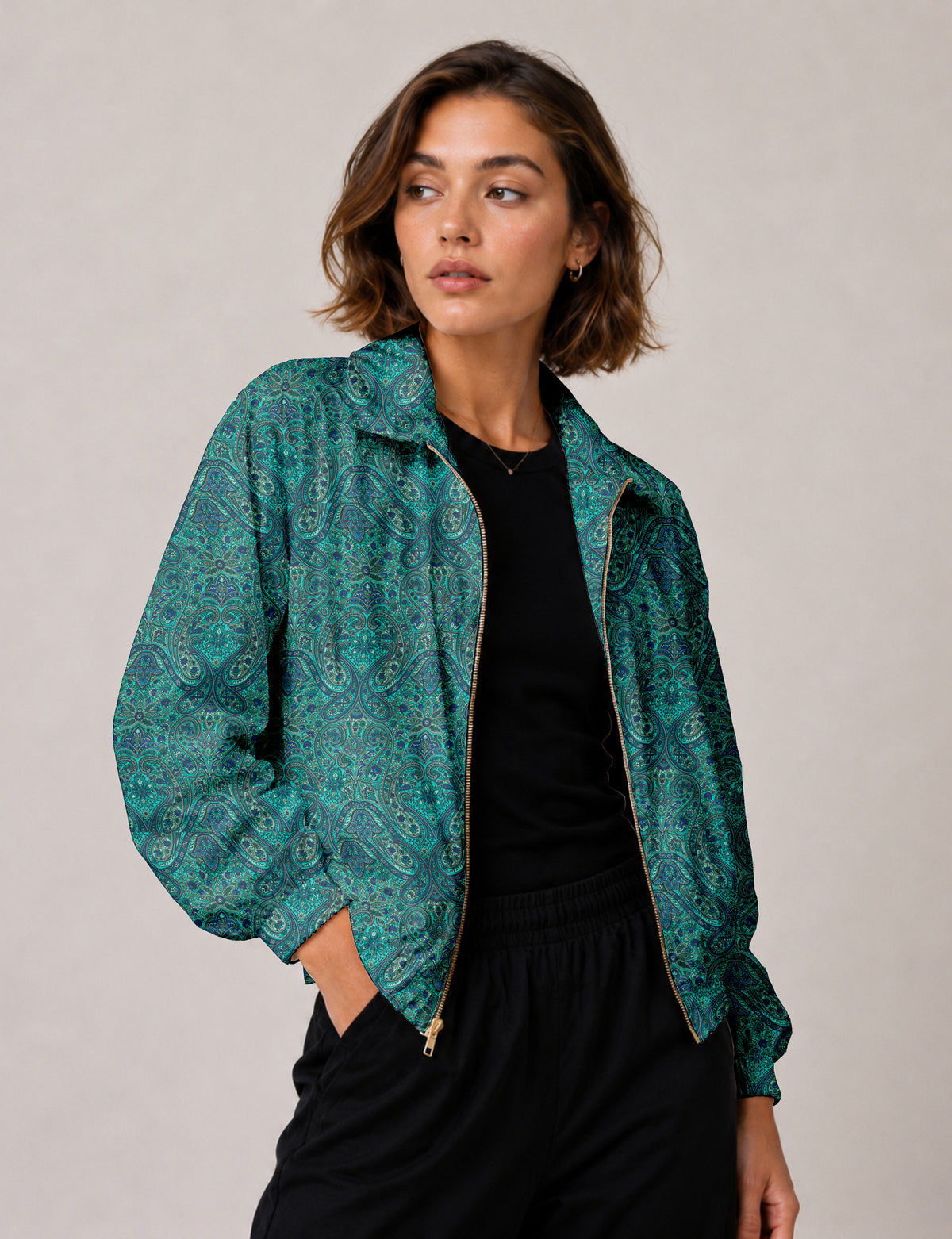 Brown floral bomber jacket with front zipper, elastic cuffs and hem, hanging on white hanger, red floral inner lining visible