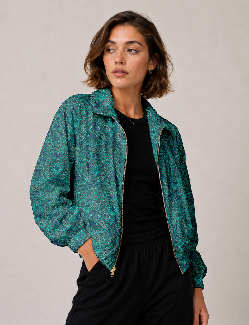 Brown floral bomber jacket with front zipper, elastic cuffs and hem, hanging on white hanger, red floral inner lining visible