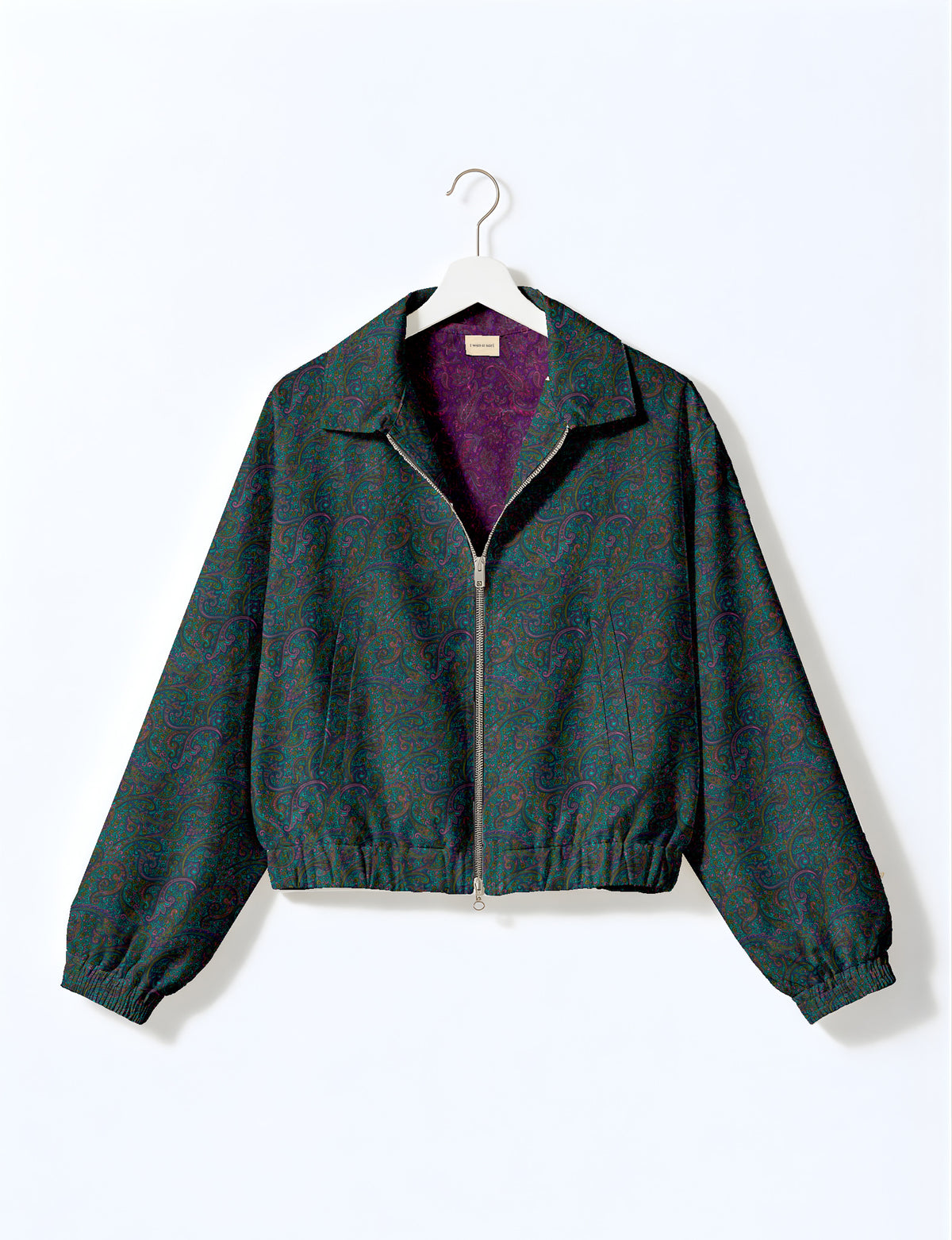 Brown floral bomber jacket with front zipper, elastic cuffs and hem, hanging on white hanger, red floral inner lining visible