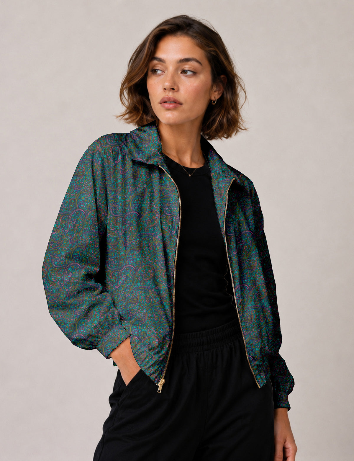 Brown floral bomber jacket with front zipper, elastic cuffs and hem, hanging on white hanger, red floral inner lining visible