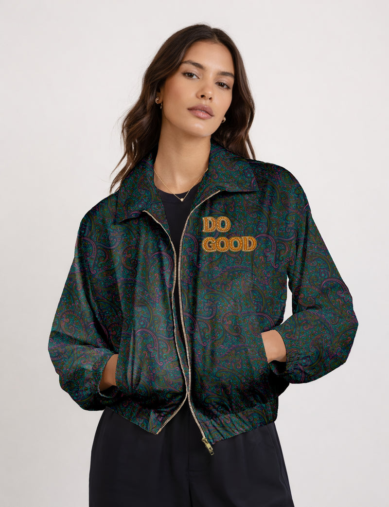 Gold cropped DO GOOD bomber jacket featuring hand-embroidered lettering on the left chest, contrasting inner lining and two functional pockets.