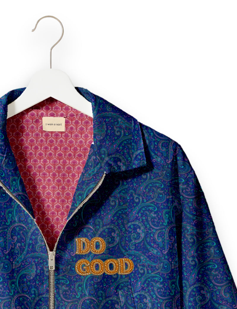 Gold cropped DO GOOD bomber jacket featuring hand-embroidered lettering on the left chest, contrasting inner lining and two functional pockets.