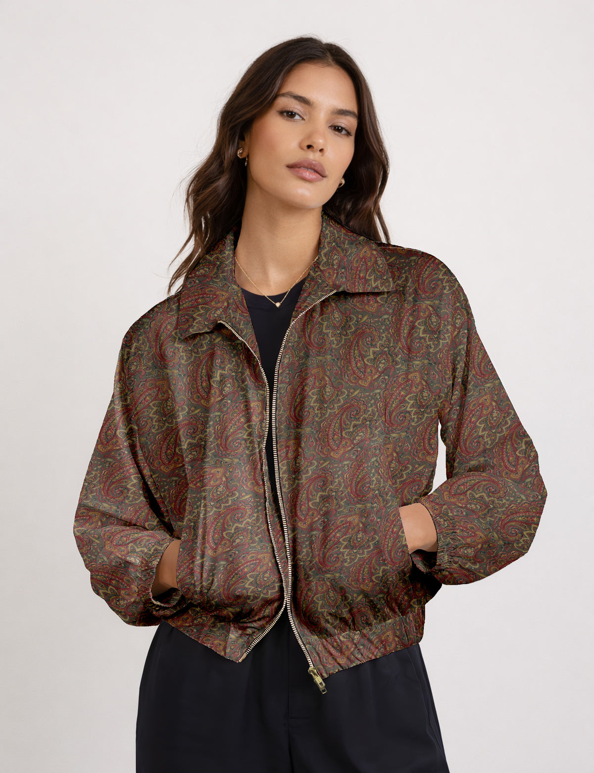 Brown floral bomber jacket with front zipper, elastic cuffs and hem, hanging on white hanger, red floral inner lining visible