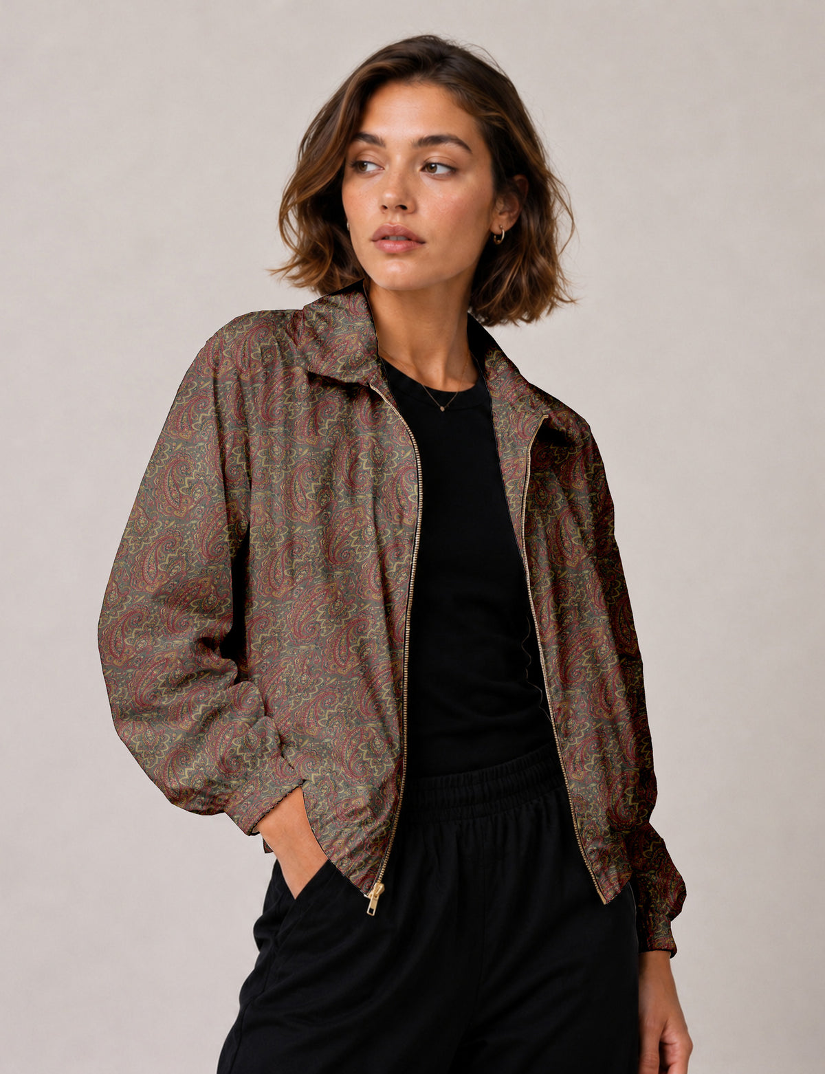 Brown floral bomber jacket with front zipper, elastic cuffs and hem, hanging on white hanger, red floral inner lining visible