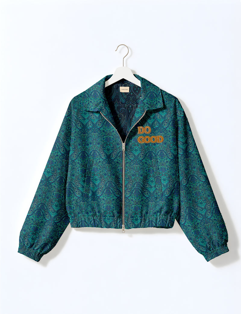 Gold cropped DO GOOD bomber jacket featuring hand-embroidered lettering on the left chest, contrasting inner lining and two functional pockets.