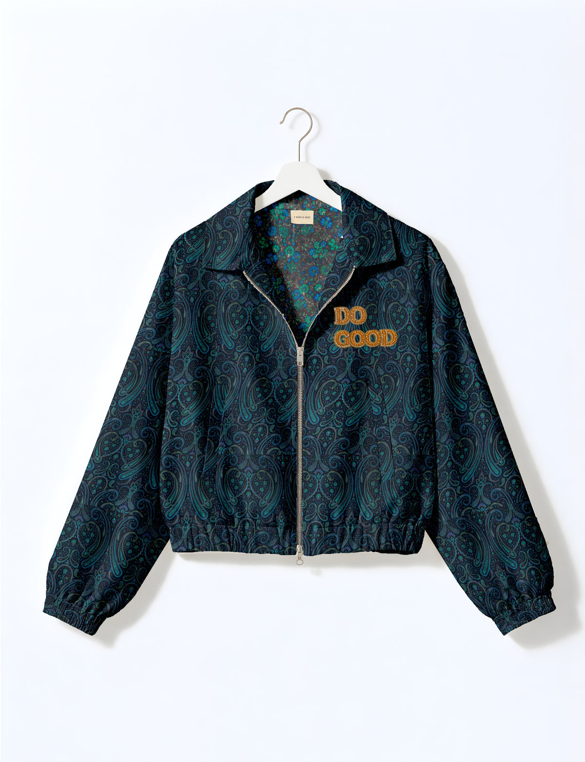 Gold cropped DO GOOD bomber jacket featuring hand-embroidered lettering on the left chest, contrasting inner lining and two functional pockets.