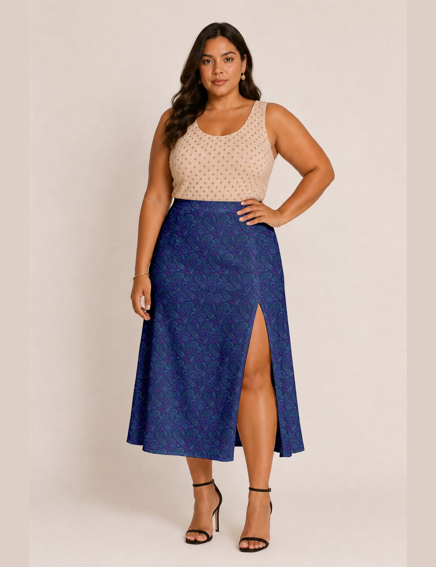 Woman wearing a yellow and black micro patterned A-line skirt with front slit, paired with beige sleeveless top and black