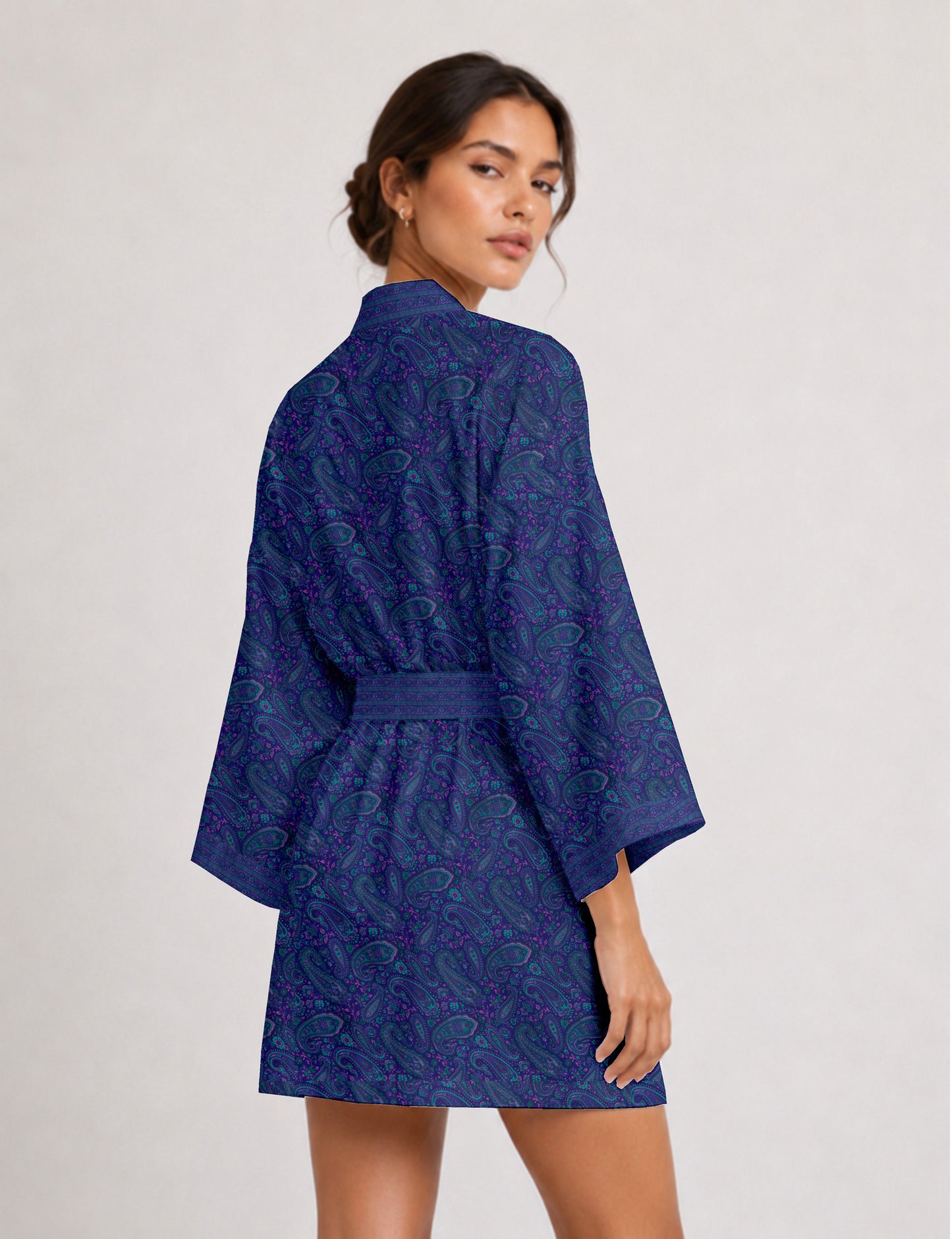 Short kimono robe with wrap front, V-neckline, wide sleeves, waist tie, and concealed skort detail.