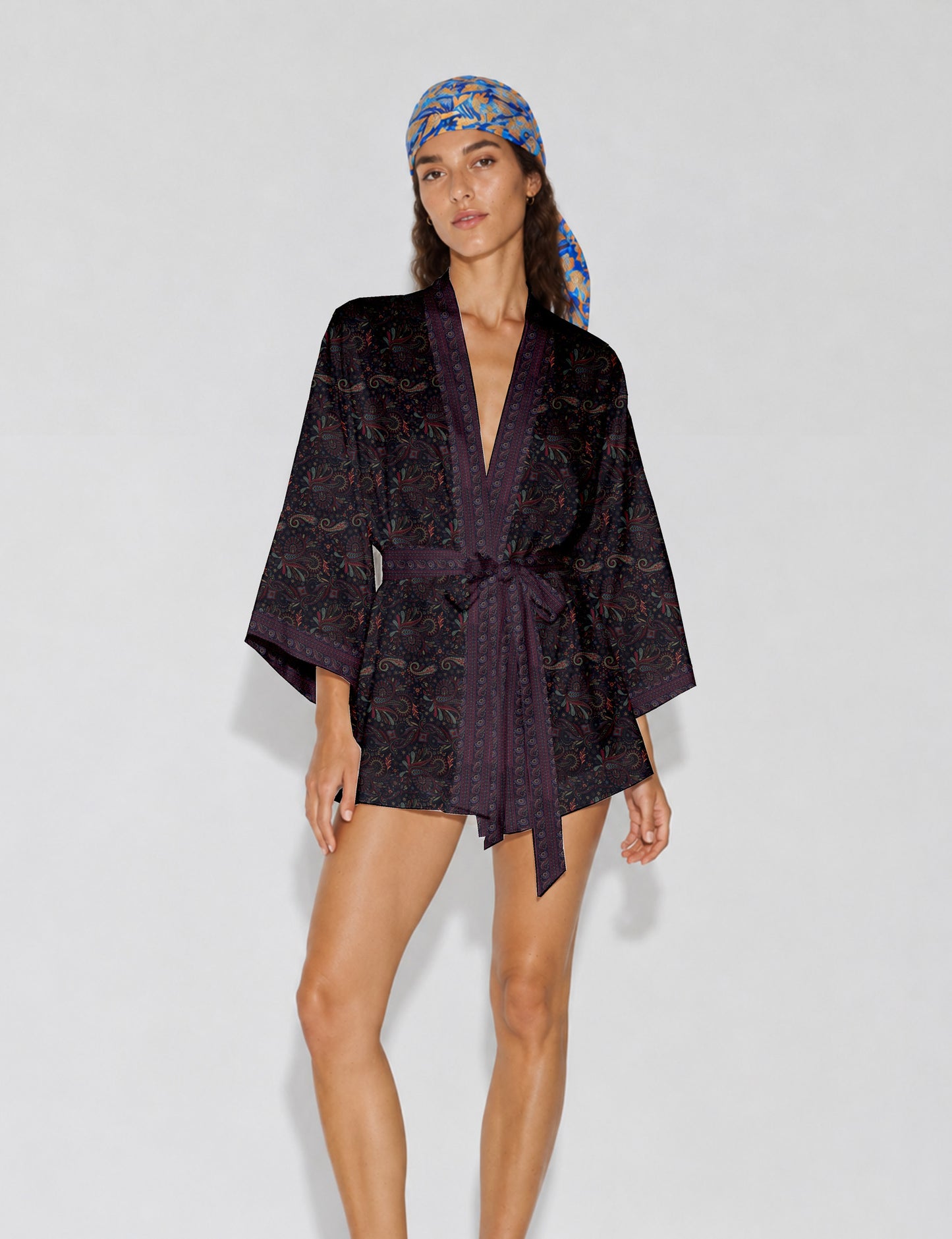 Short kimono robe with wrap front, V-neckline, wide sleeves, waist tie, and concealed skort detail.