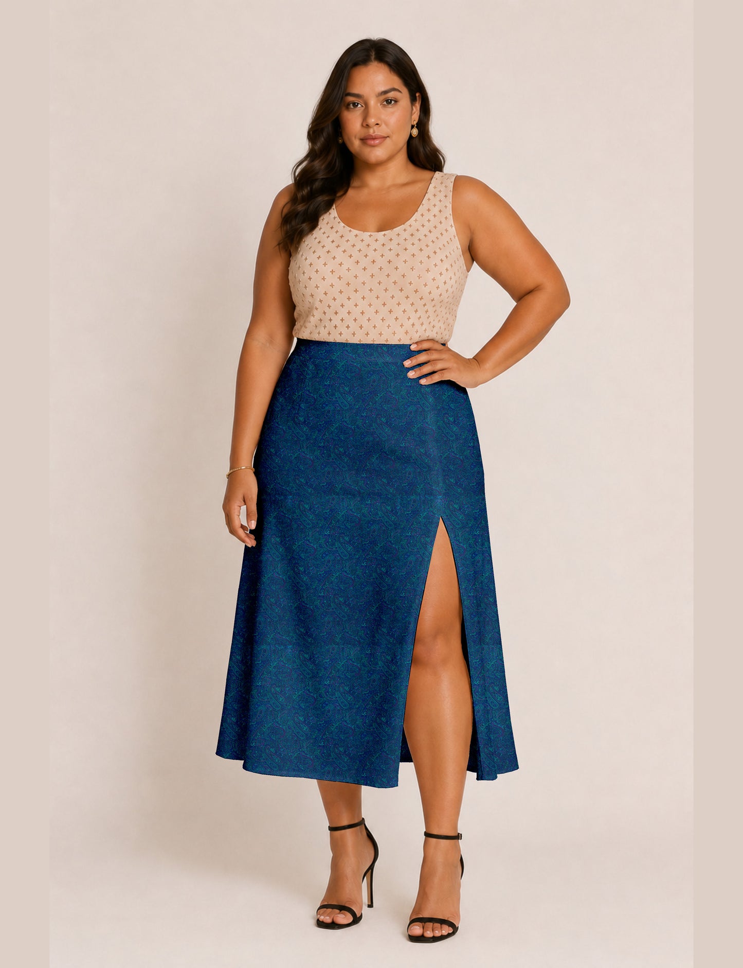 Woman wearing a yellow and black micro patterned A-line skirt with front slit, paired with beige sleeveless top and black