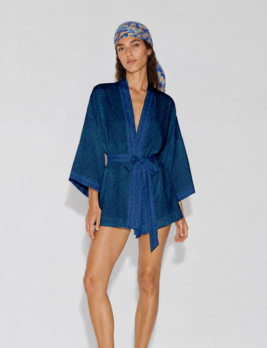Short kimono robe with wrap front, V-neckline, wide sleeves, waist tie, and concealed skort detail.