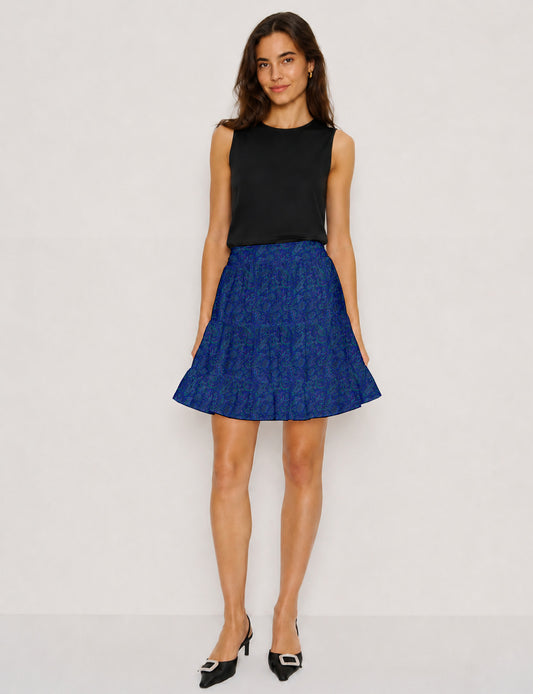 Short tiered skirt with a fitted waistband, knife pleats, softly flared silhouette, side seam pockets, and above-the-knee length.