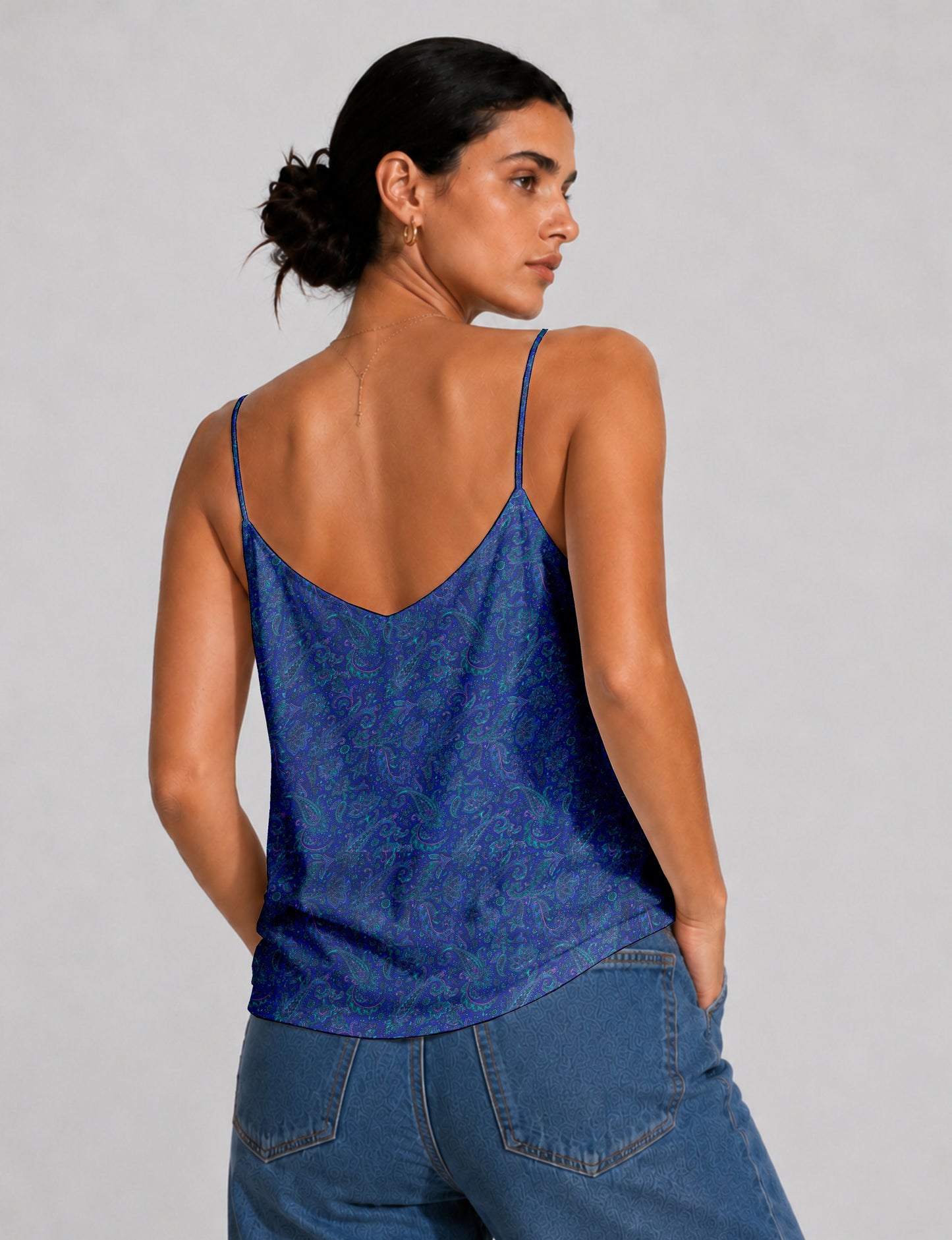 Women's sleeveless slip top with a relaxed straight fit, soft V-neckline, deep V-back, and delicate spaghetti straps.