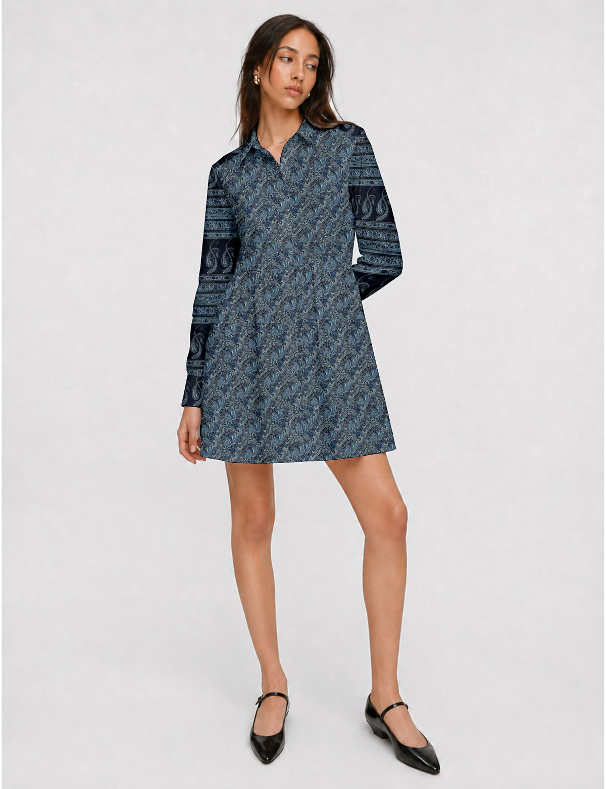 Short shirt dress with a relaxed A-line silhouette, point collar, partial button placket, gathered waist, side pockets, and full-length cuffed sleeves.