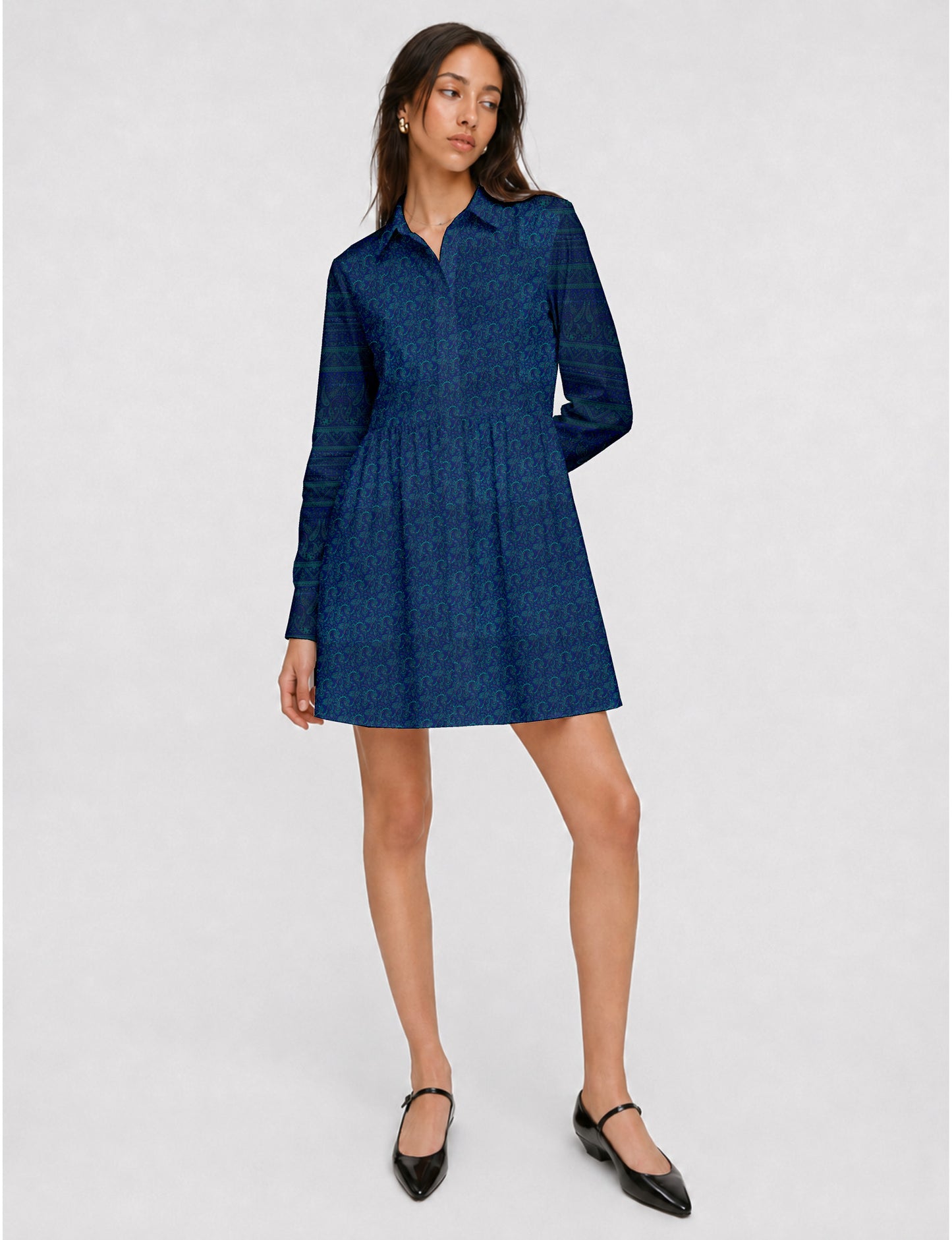 Short shirt dress with a relaxed A-line silhouette, point collar, partial button placket, gathered waist, side pockets, and full-length cuffed sleeves.