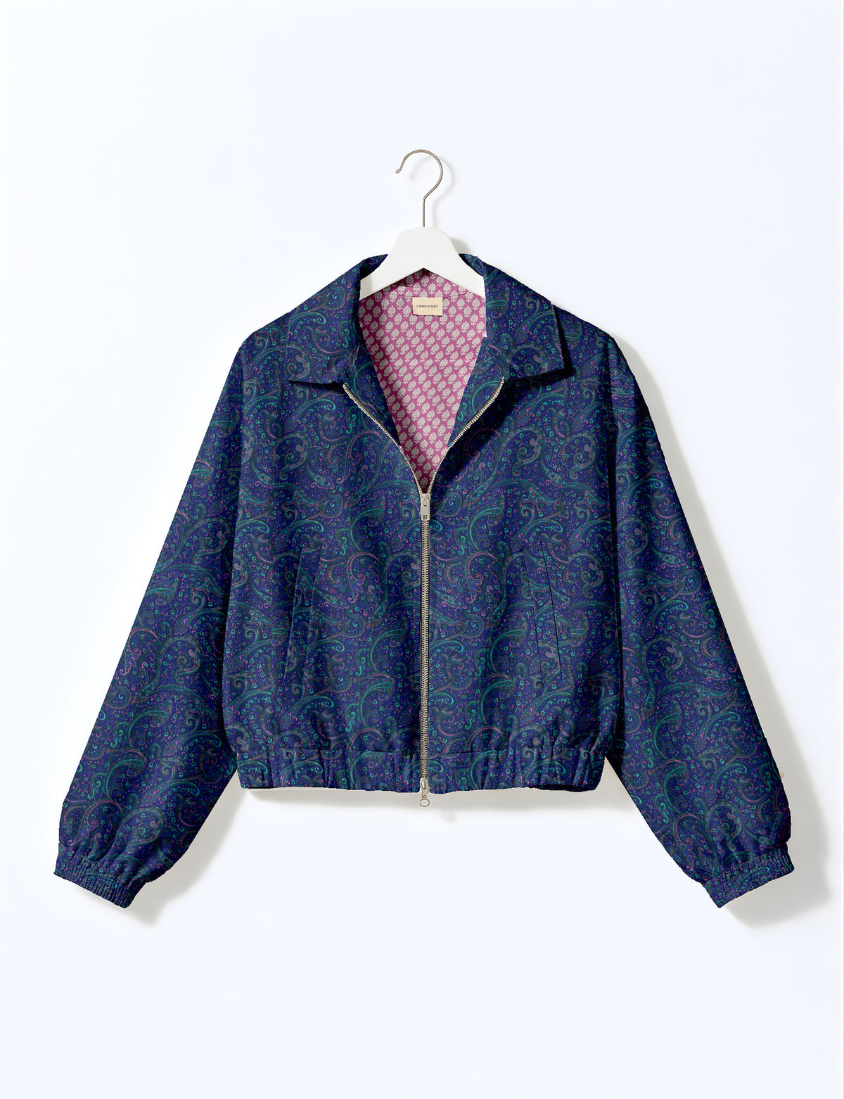 Brown floral bomber jacket with front zipper, elastic cuffs and hem, hanging on white hanger, red floral inner lining visible