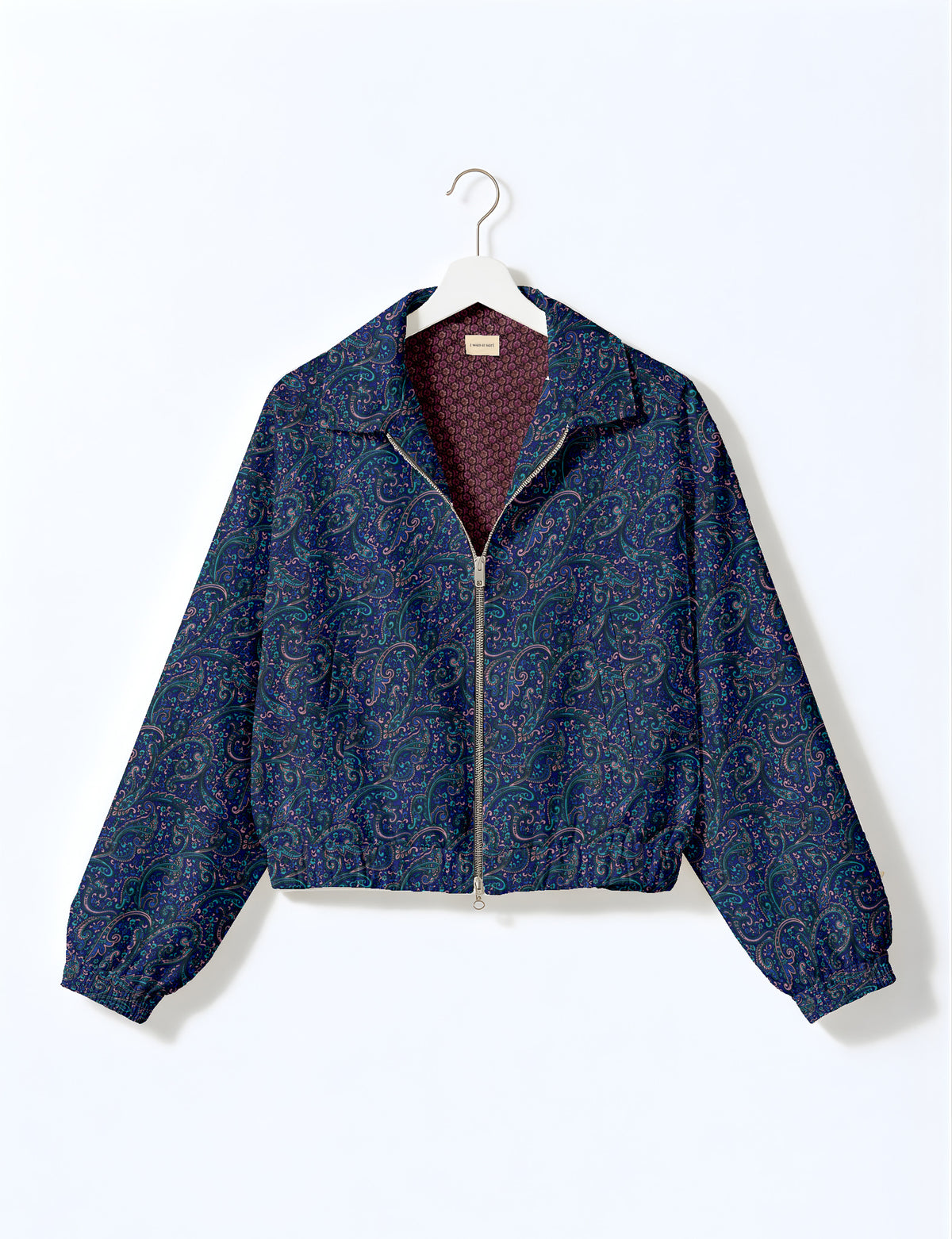 Brown floral bomber jacket with front zipper, elastic cuffs and hem, hanging on white hanger, red floral inner lining visible