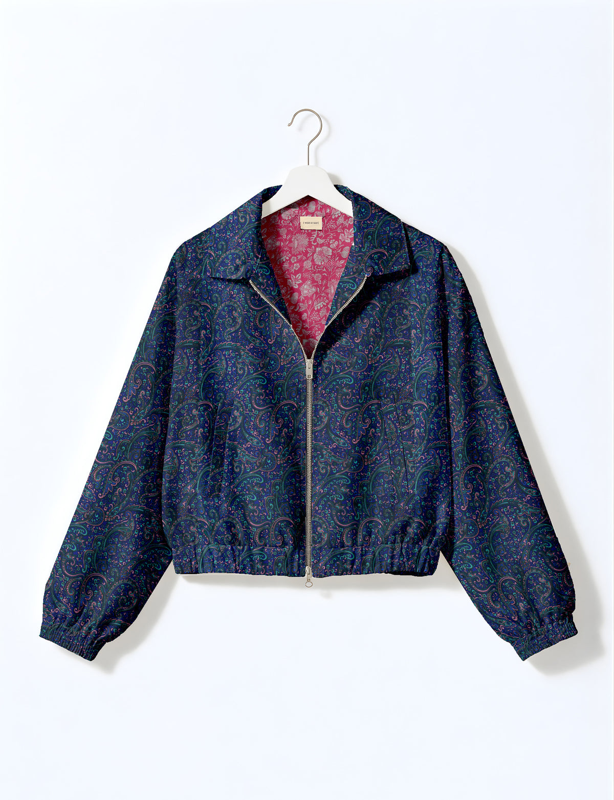 Brown floral bomber jacket with front zipper, elastic cuffs and hem, hanging on white hanger, red floral inner lining visible