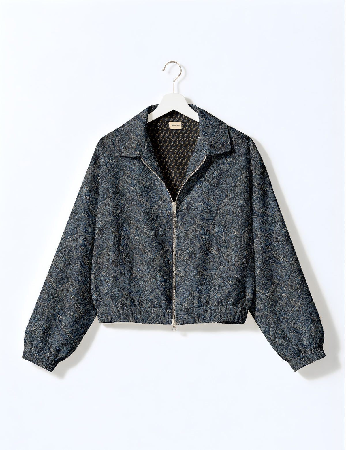 Brown floral bomber jacket with front zipper, elastic cuffs and hem, hanging on white hanger, red floral inner lining visible