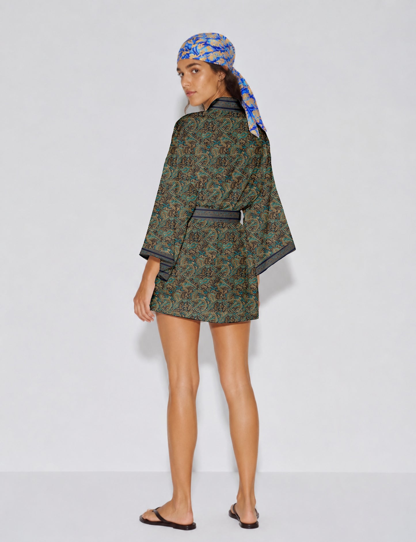 Short kimono robe with wrap front, V-neckline, wide sleeves, waist tie, and concealed skort detail.