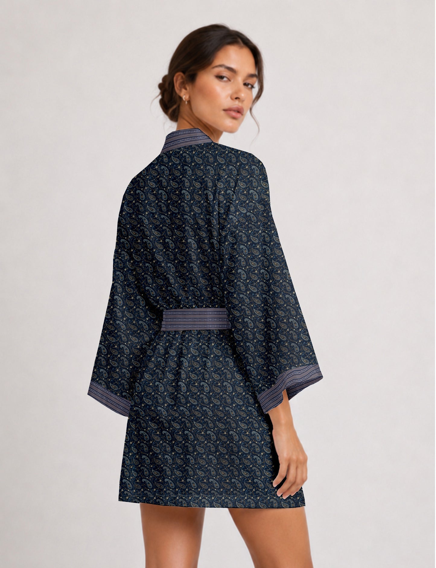 Short kimono robe with wrap front, V-neckline, wide sleeves, waist tie, and concealed skort detail.