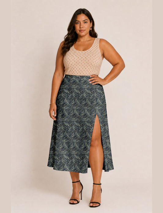 Woman wearing a yellow and black micro patterned A-line skirt with front slit, paired with beige sleeveless top and black