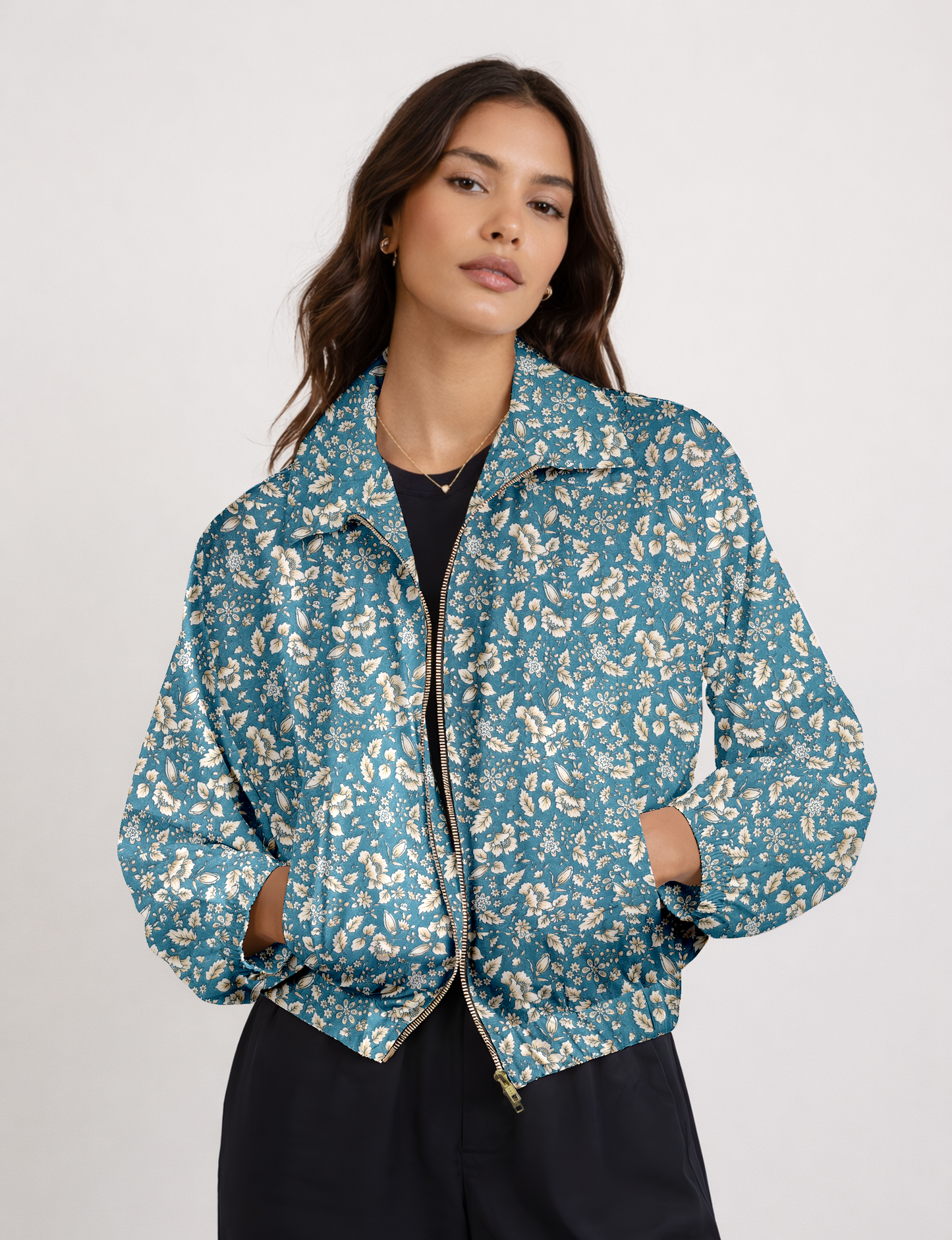 Women's cropped bomber jacket with twin metallic front zippers, welt pockets, elasticated hem and cuffs, and contrast sari print lining.