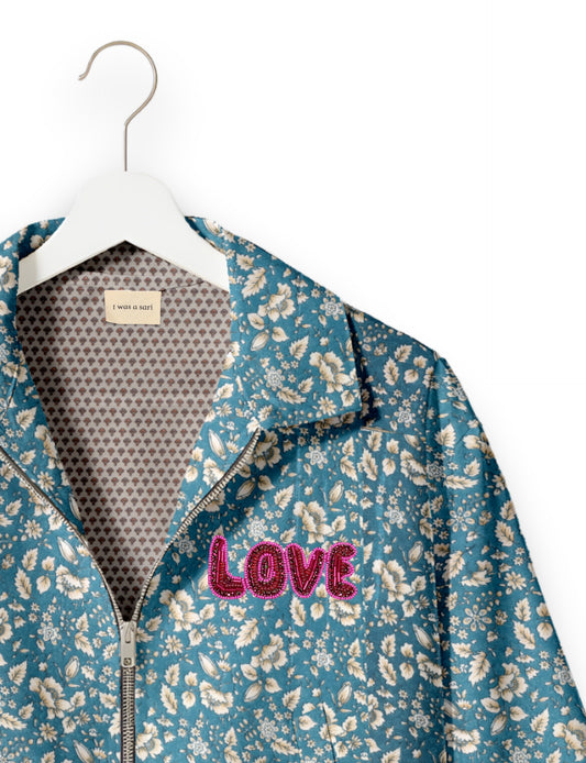 Love Bomber Jacket made from recycled fabric, featuring hand-stitched Aari embroidery. A unique piece of zero-waste clothing, part of the circular fashion movement. Designed with upcycled materials for a stylish yet environmentally friendly clothing choice.